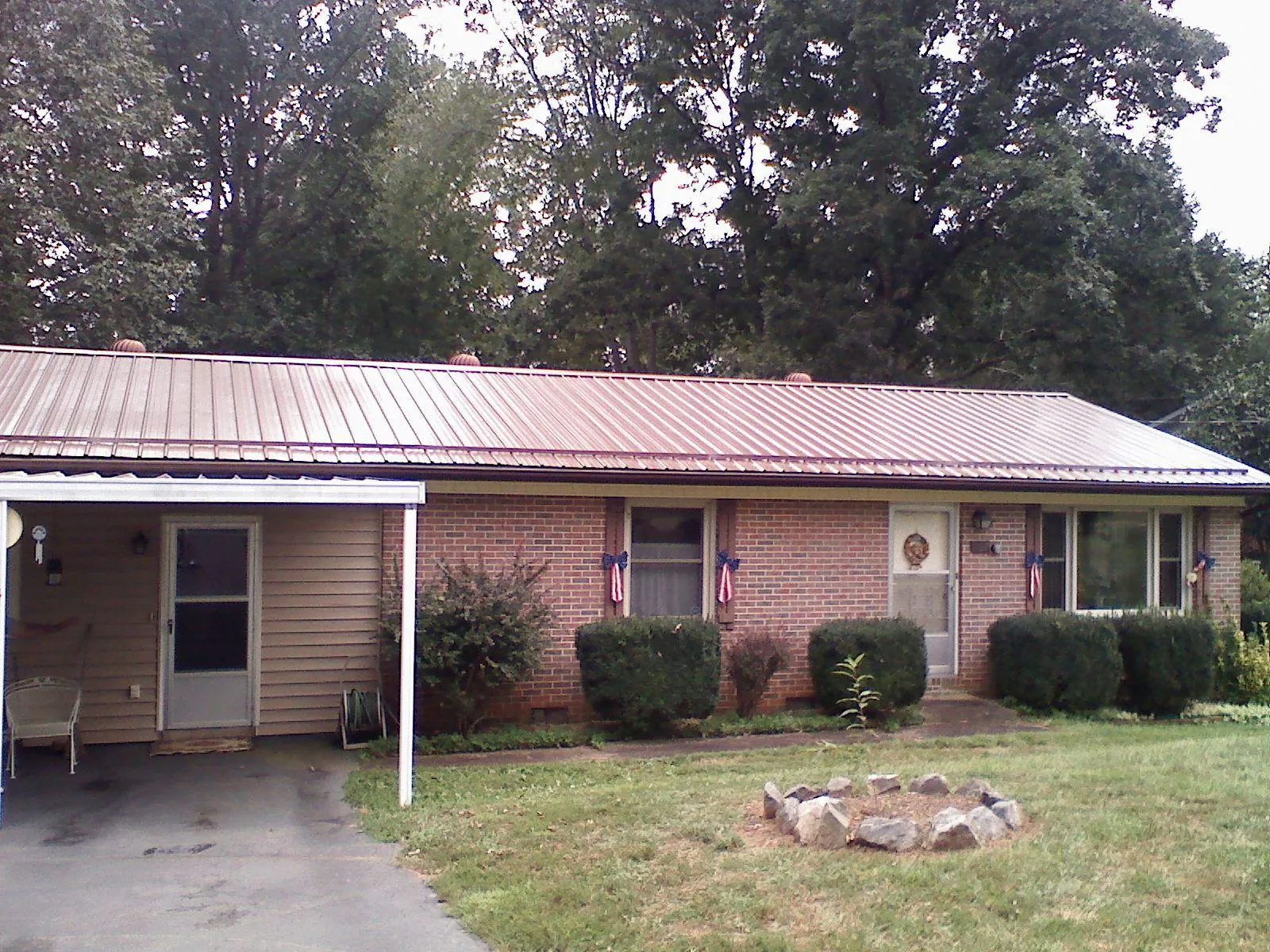 Bronze metal roof and carport on a brick ranch home — Roof Repair work by our crew in Niantic
